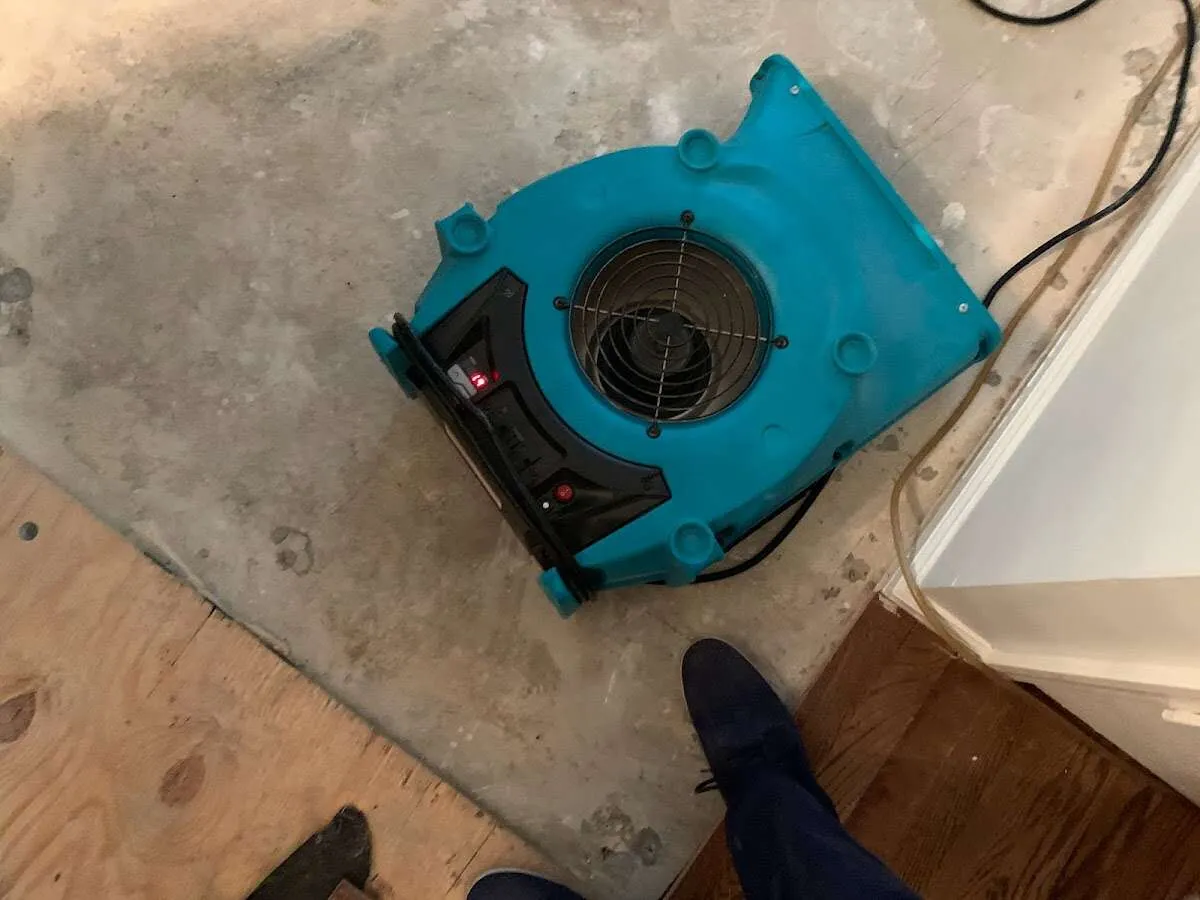 Air mover drying subfloor during Leak Detection & Repair in Snyder